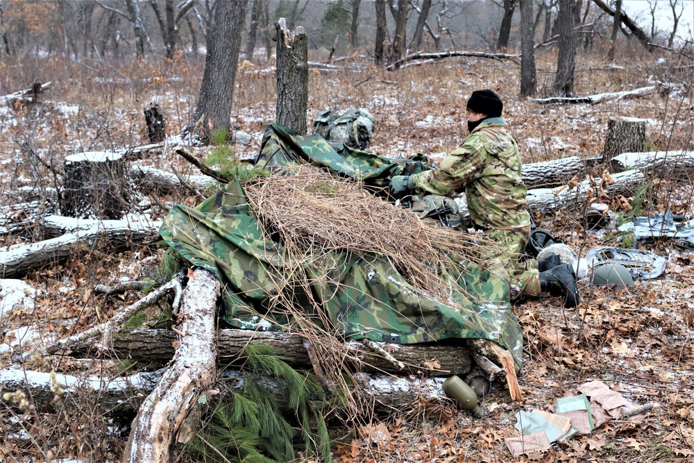 Cold-Weather Operations Course students build improvised shelters, survive outdoors