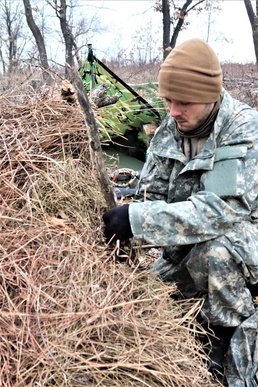 Cold-Weather Operations Course students build improvised shelters, survive outdoors