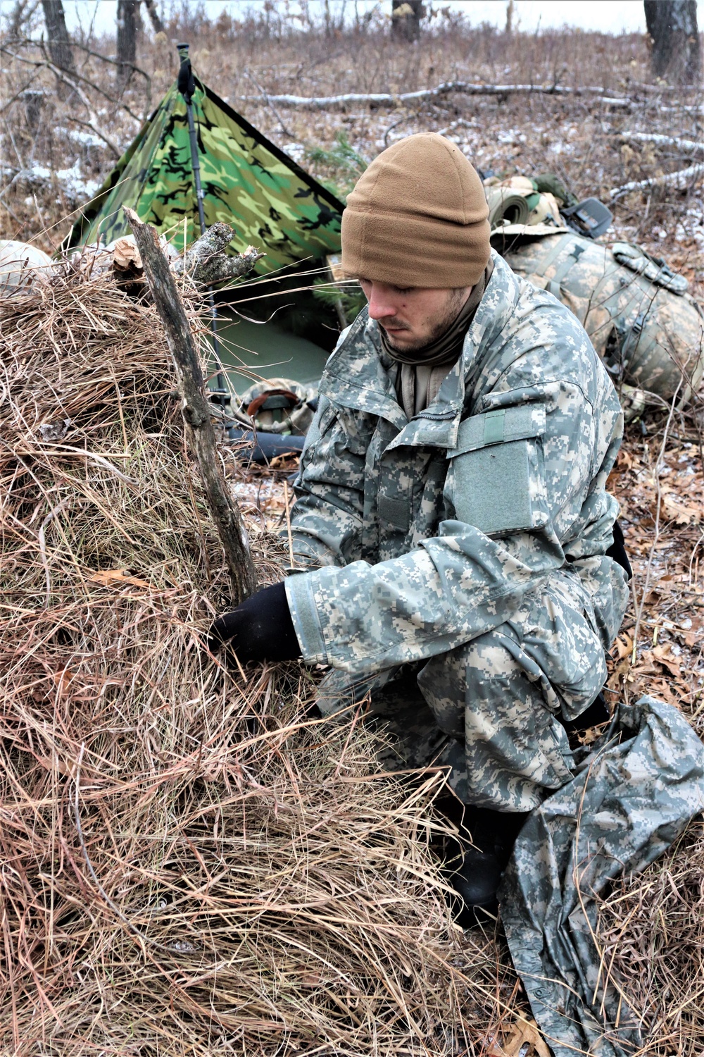 Cold-Weather Operations Course students build improvised shelters, survive outdoors