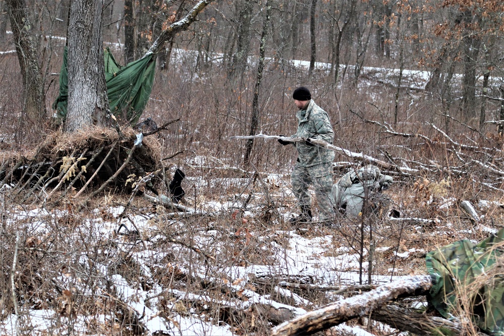 Cold-Weather Operations Course students build improvised shelters, survive outdoors