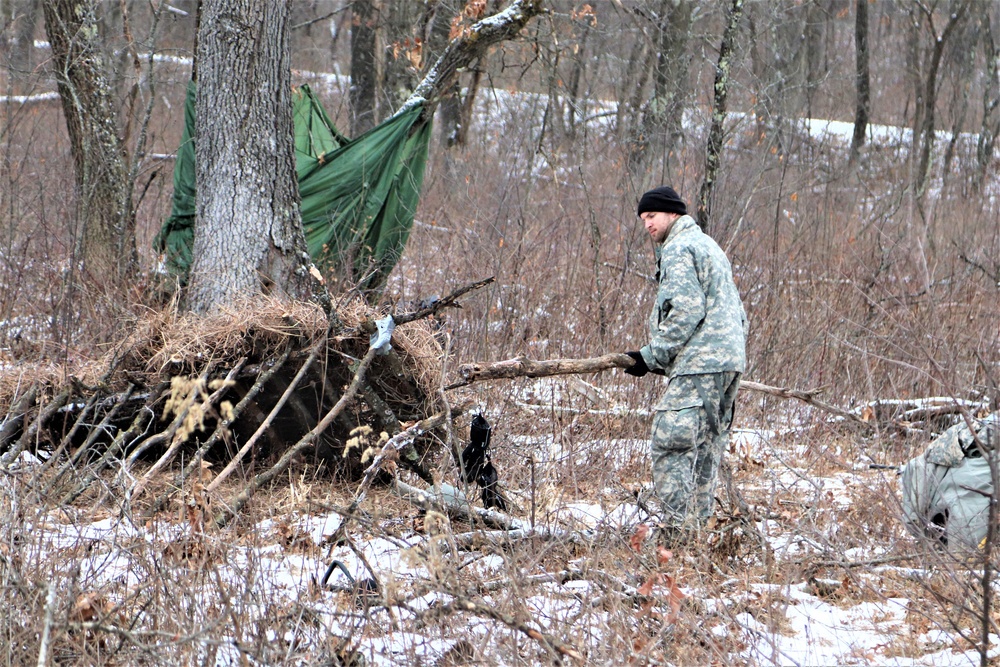 Cold-Weather Operations Course students build improvised shelters, survive outdoors