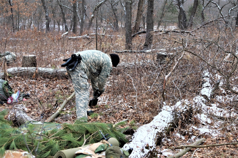 Cold-Weather Operations Course students build improvised shelters, survive outdoors