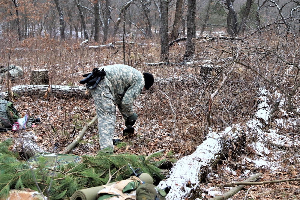 Cold-Weather Operations Course students build improvised shelters, survive outdoors