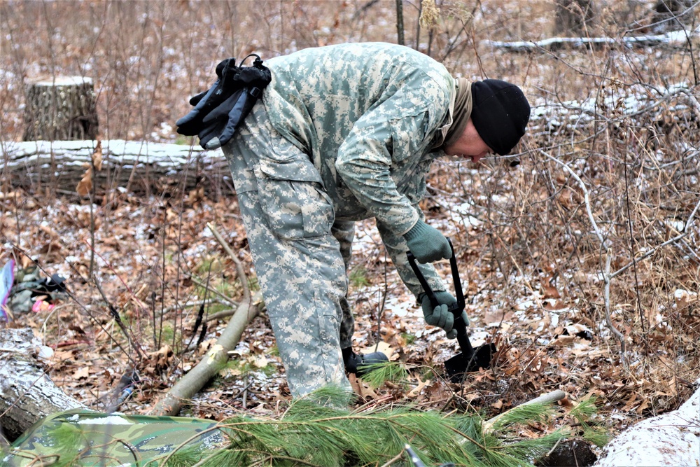 Cold-Weather Operations Course students build improvised shelters, survive outdoors