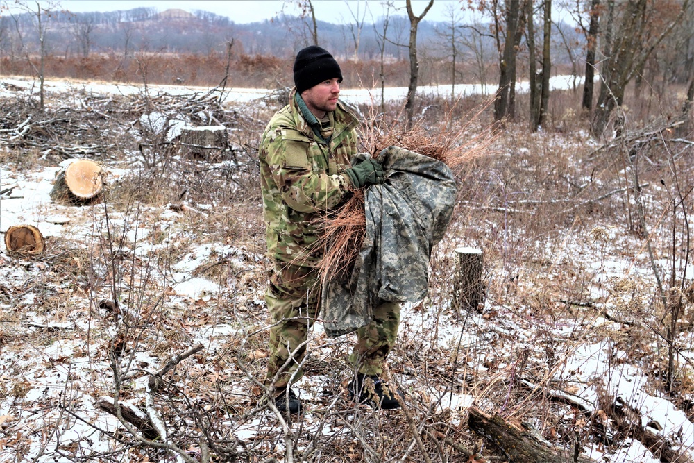 Cold-Weather Operations Course students build improvised shelters, survive outdoors