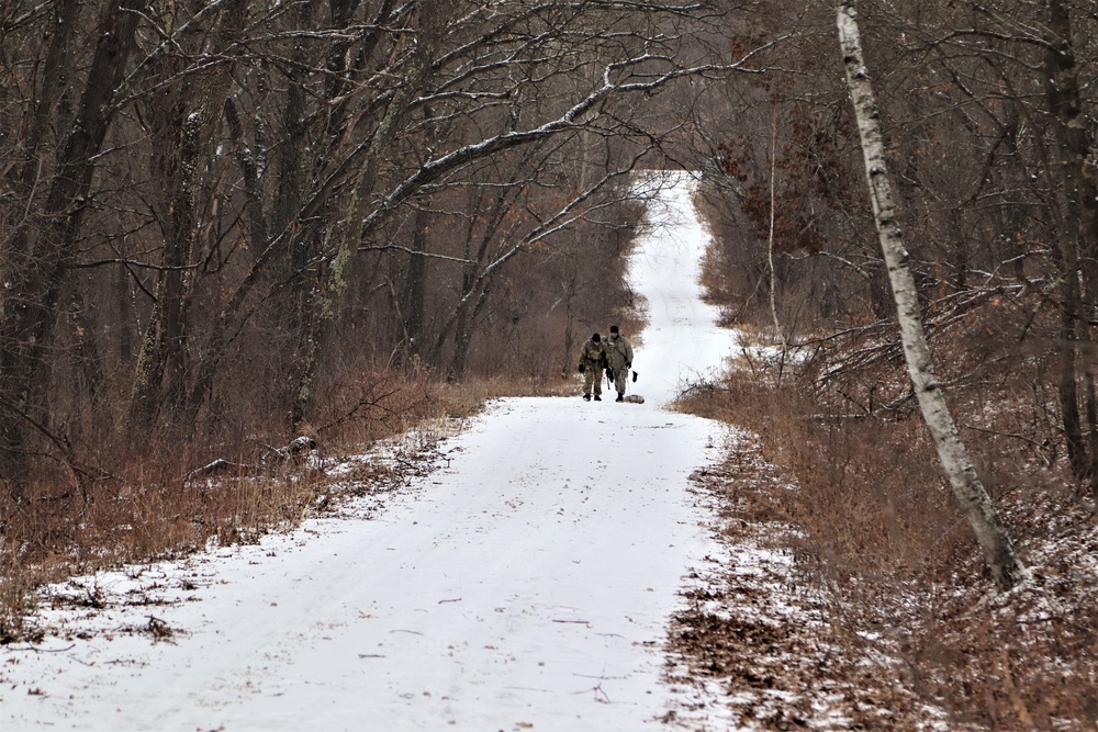 Cold-Weather Operations Course students build improvised shelters, survive outdoors