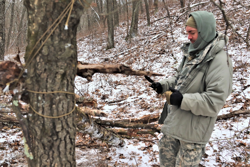 Cold-Weather Operations Course students build improvised shelters, survive outdoors