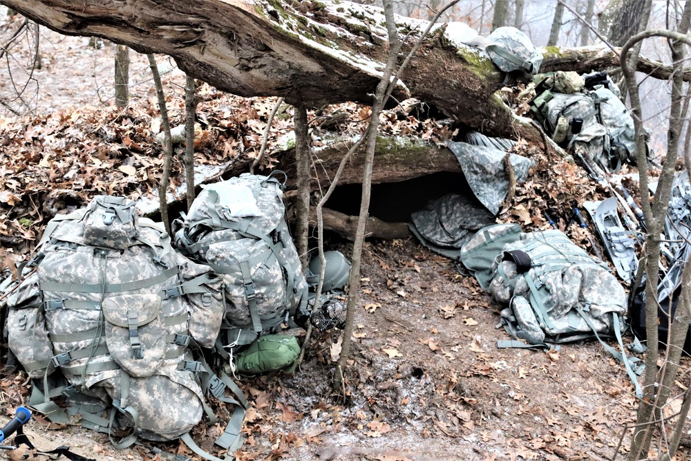 Cold-Weather Operations Course students build improvised shelters, survive outdoors