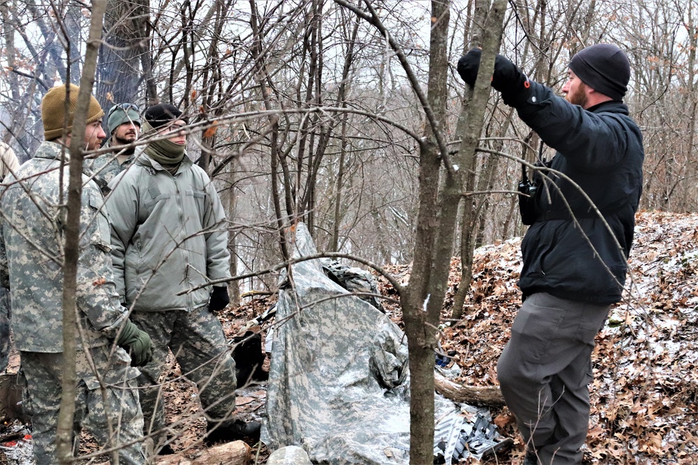 Cold-Weather Operations Course students build improvised shelters, survive outdoors