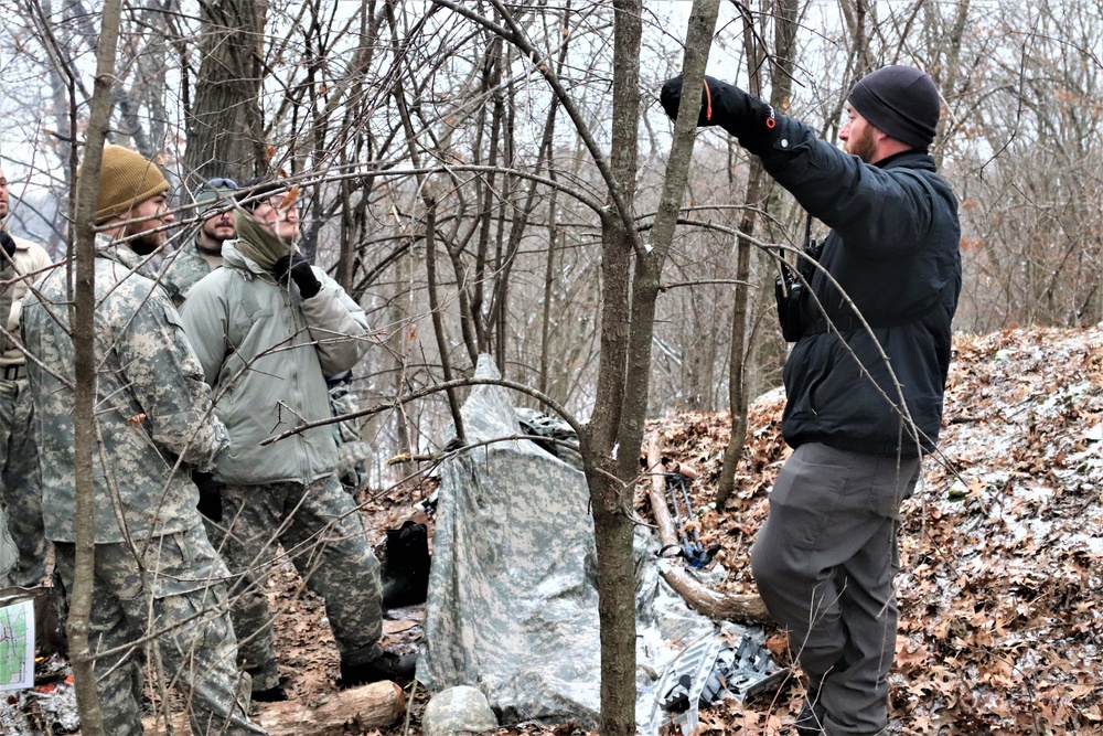 Cold-Weather Operations Course students build improvised shelters, survive outdoors