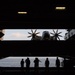U.S. Sailors observe a C-2A Greyhound on an aircraft elevator
