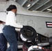 U.S. Sailor unloads tires from a C-2A Greyhound