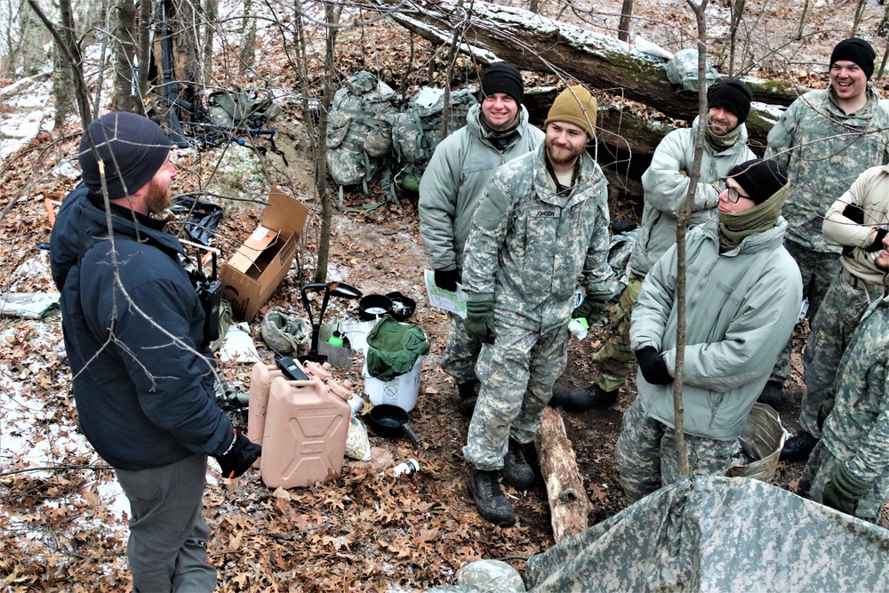 Cold-Weather Operations Course students build improvised shelters, survive outdoors