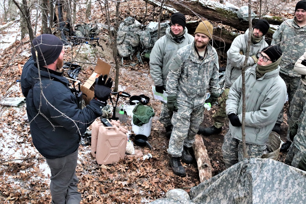 Cold-Weather Operations Course students build improvised shelters, survive outdoors