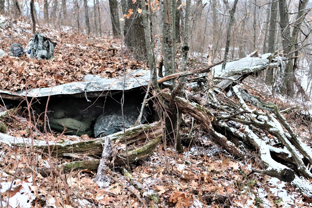 Cold-Weather Operations Course students build improvised shelters, survive outdoors