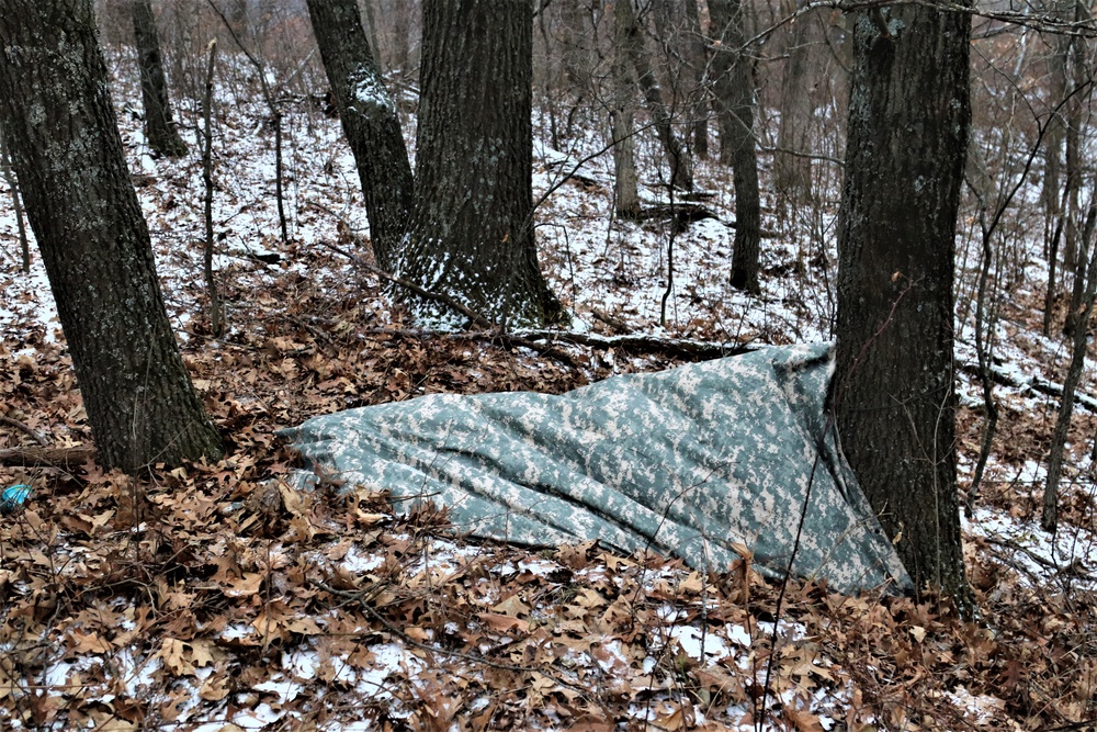 Cold-Weather Operations Course students build improvised shelters, survive outdoors