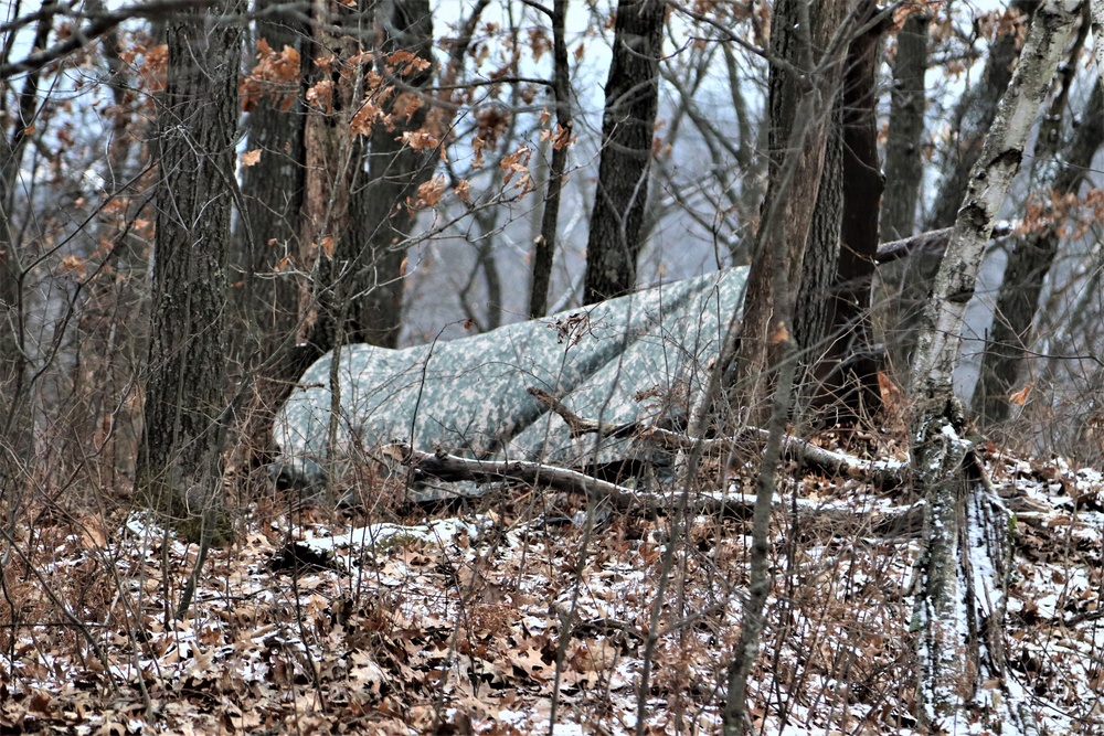 Cold-Weather Operations Course students build improvised shelters, survive outdoors