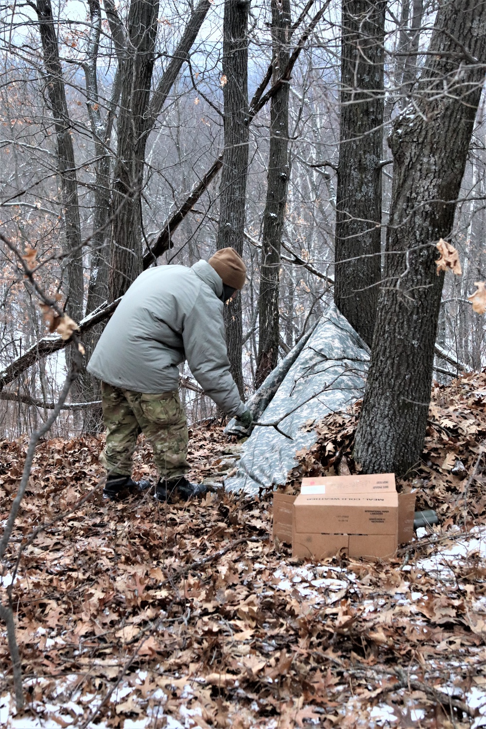 Cold-Weather Operations Course students build improvised shelters, survive outdoors