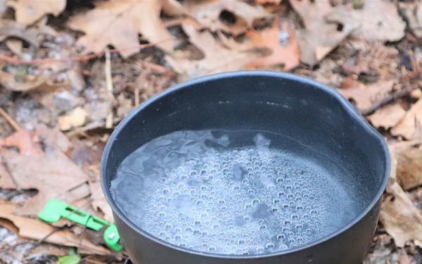 Cold-Weather Operations Course students build improvised shelters, survive outdoors