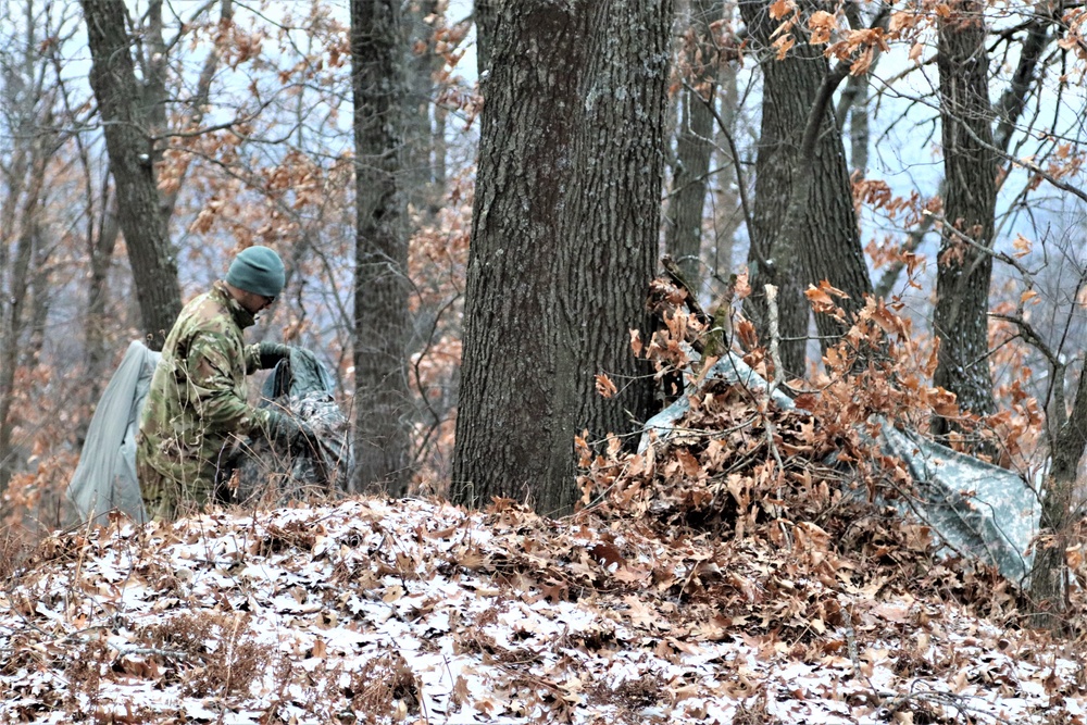 Cold-Weather Operations Course students build improvised shelters, survive outdoors