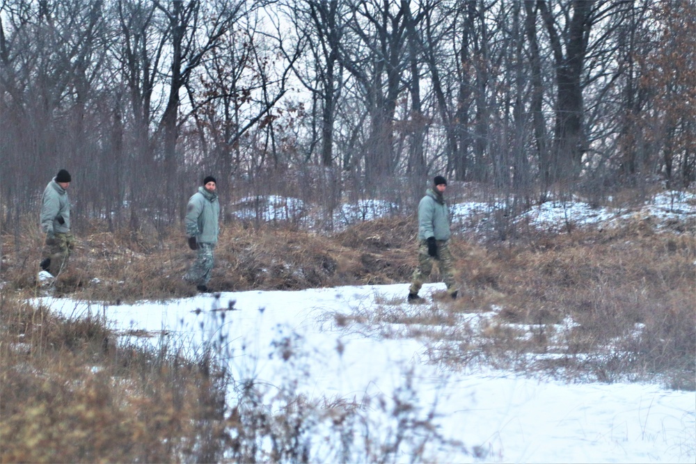 Cold-Weather Operations Course students build improvised shelters, survive outdoors