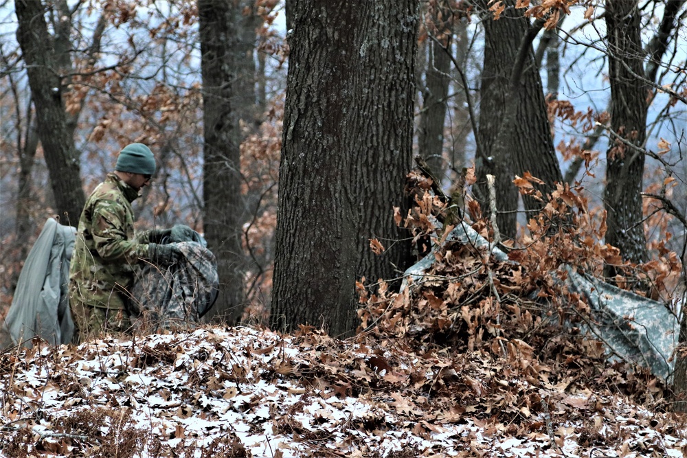 Cold-Weather Operations Course students build improvised shelters, survive outdoors