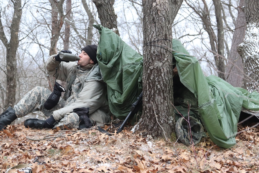 Cold-Weather Operations Course students build improvised shelters, survive outdoors