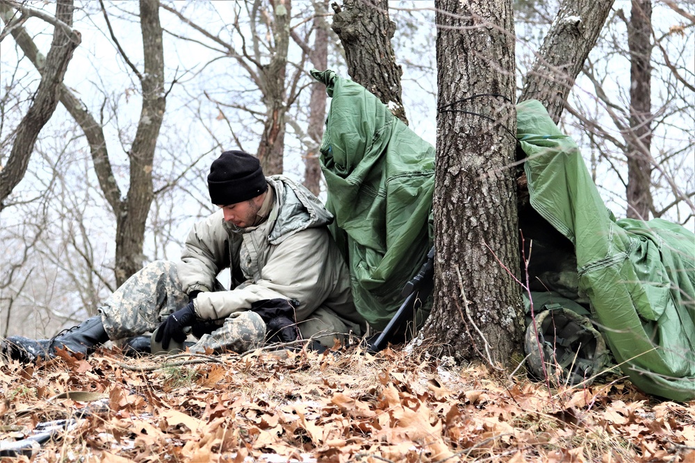 Cold-Weather Operations Course students build improvised shelters, survive outdoors