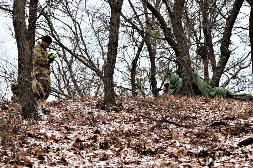 Cold-Weather Operations Course students build improvised shelters, survive outdoors