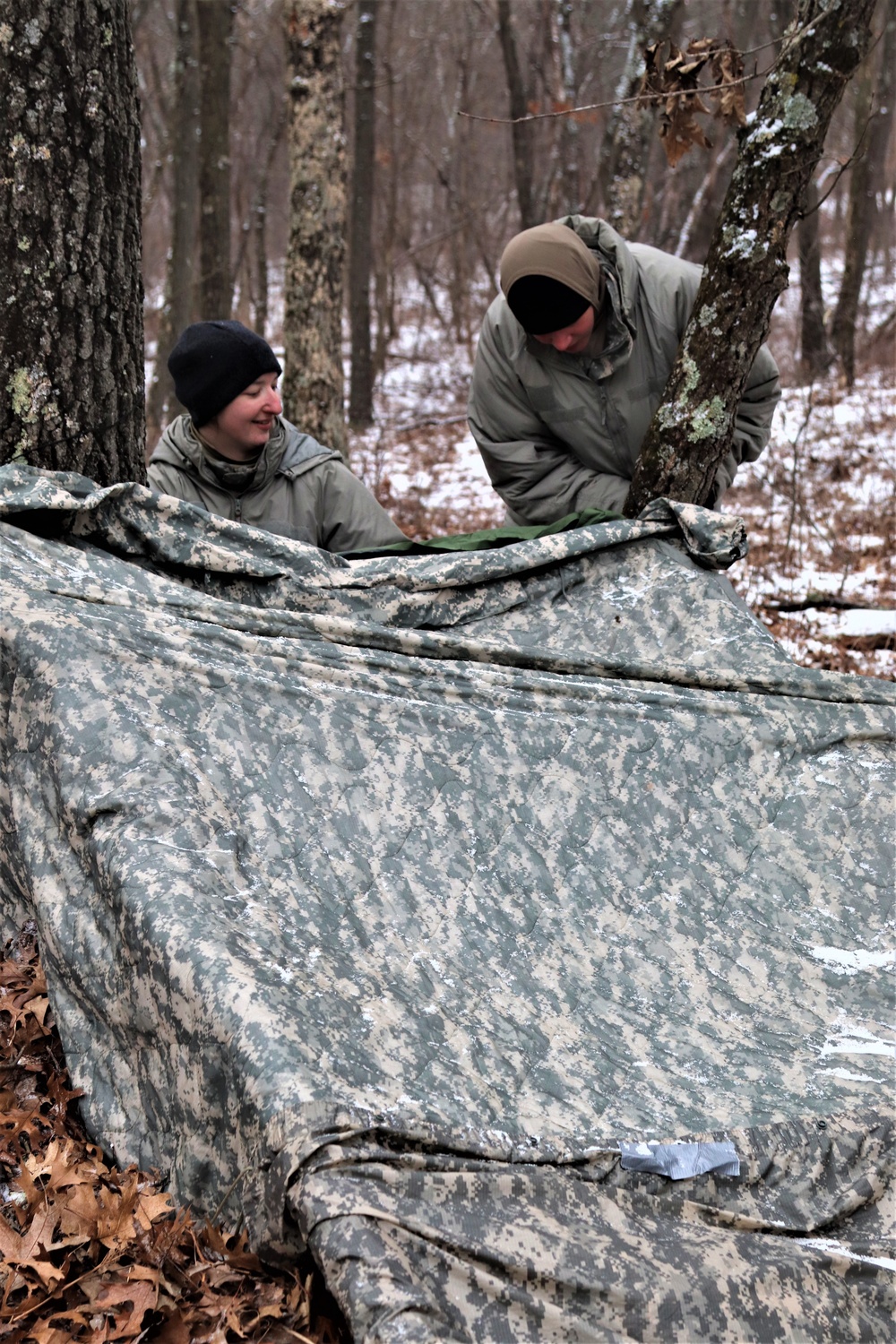 Cold-Weather Operations Course students build improvised shelters, survive outdoors