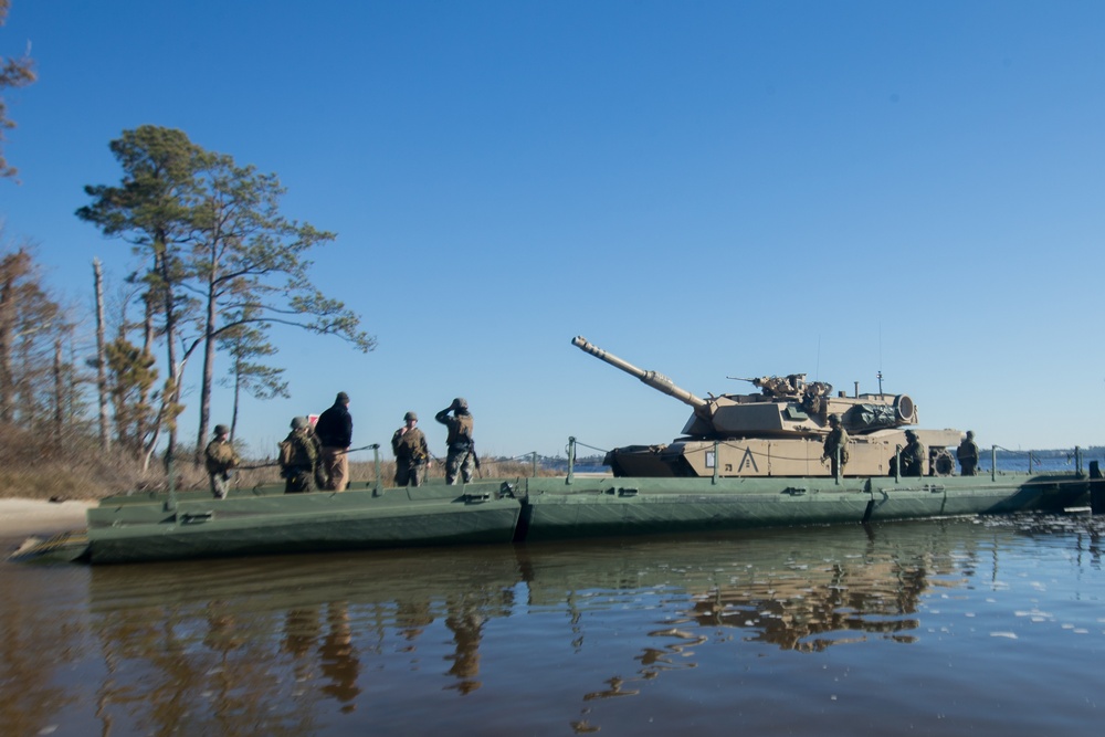 Marines use bridging techniques to move tanks across 2 miles of open water