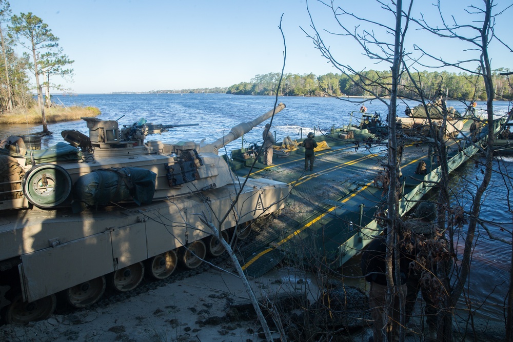 Marines use bridging techniques to move tanks across 2 miles of open water