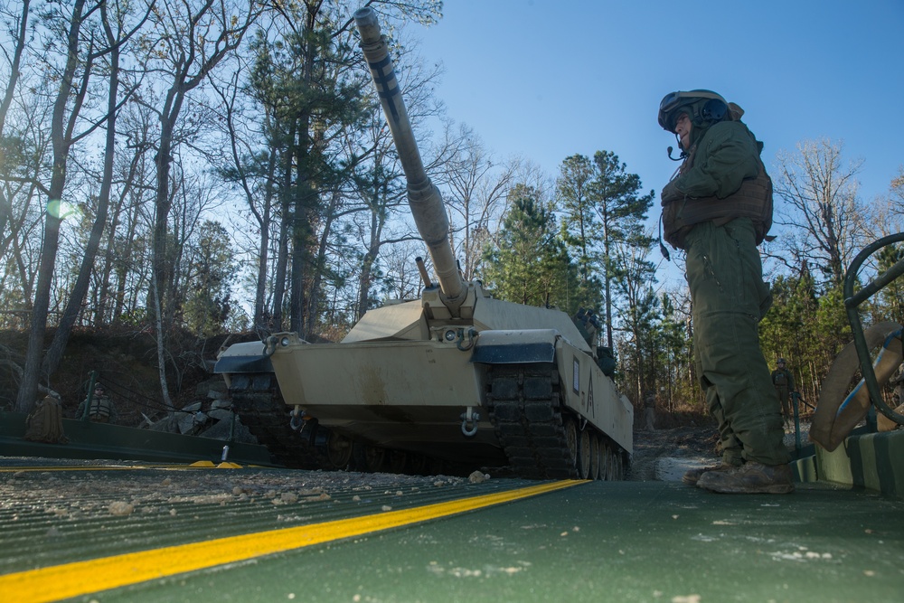 Marines use bridging techniques to move tanks across 2 miles of open water