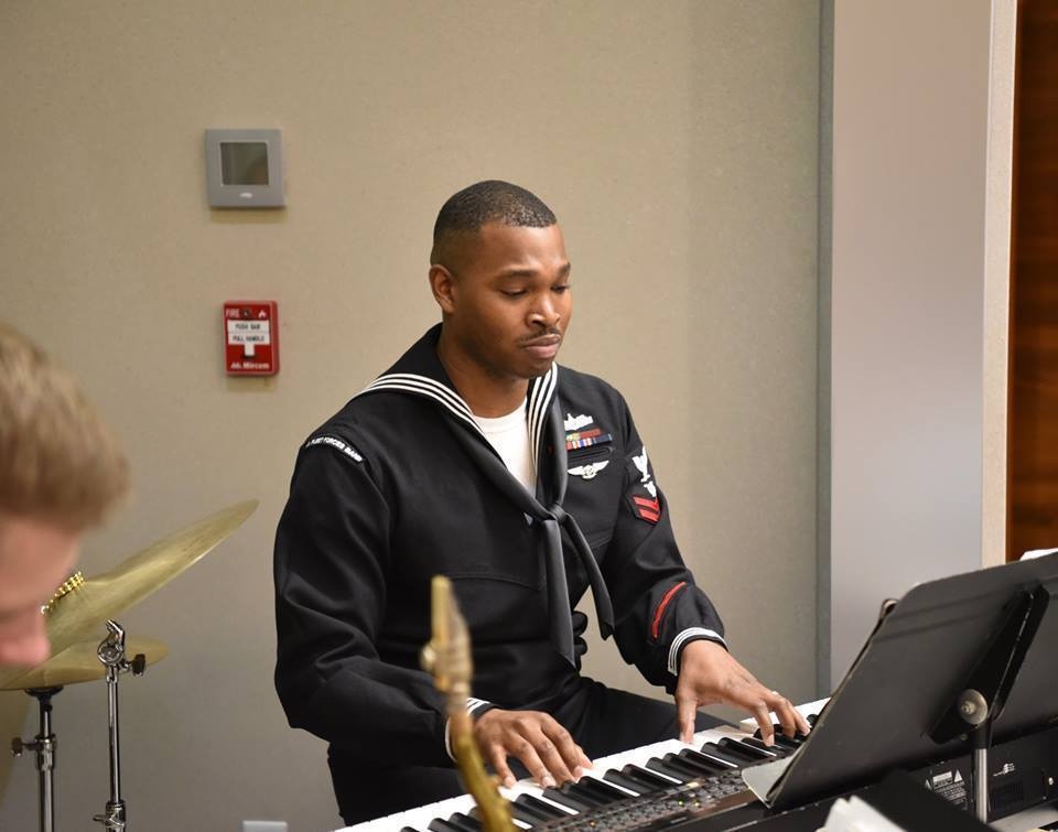 Musician Second Class Brian Mathis performs for the reception celebrating Australia Day and General MacArthur's Birthday