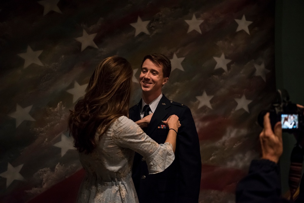 new pilot has wings pinned on by loved one