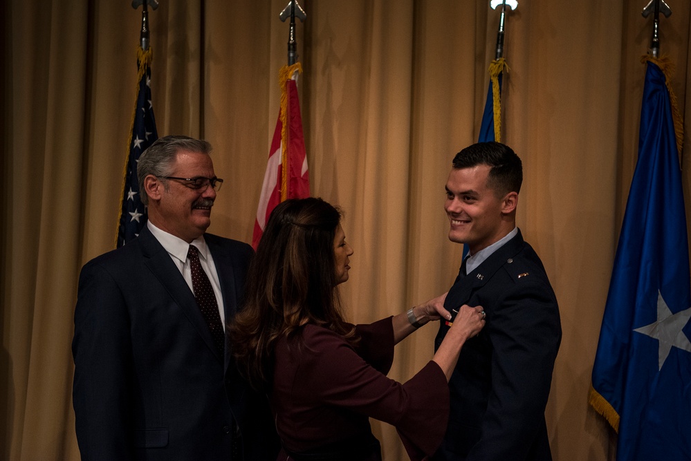 new pilot has wings pinned on by loved one