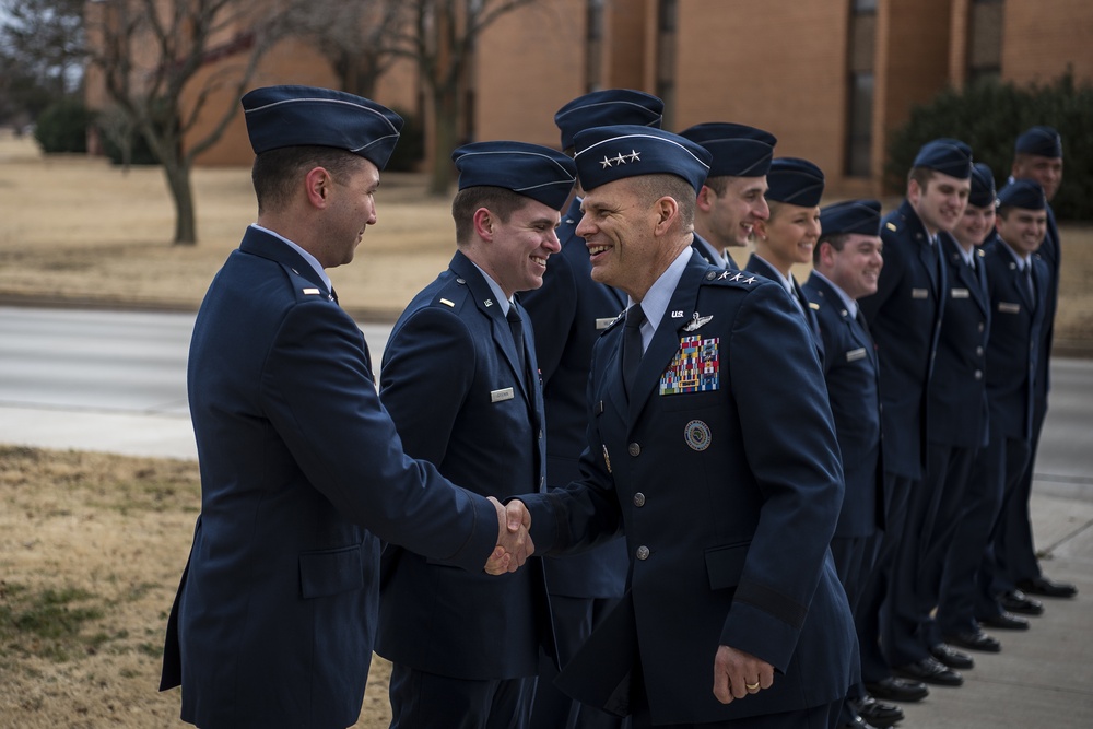 Lt. Gen. James C. Vechery shakes hands with new pilot