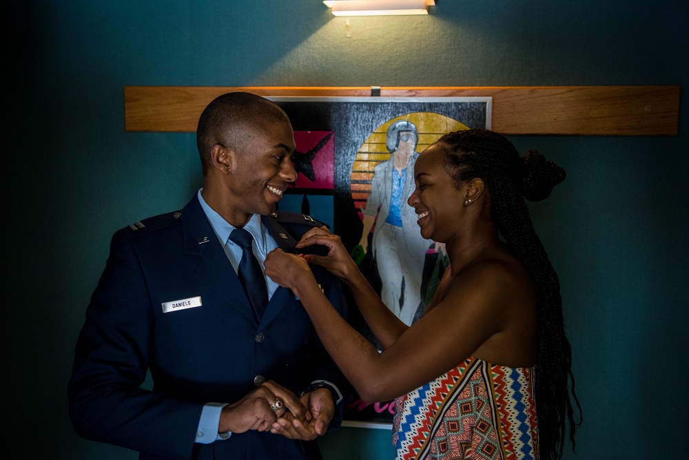 New pilot has wings pinned on by loved one