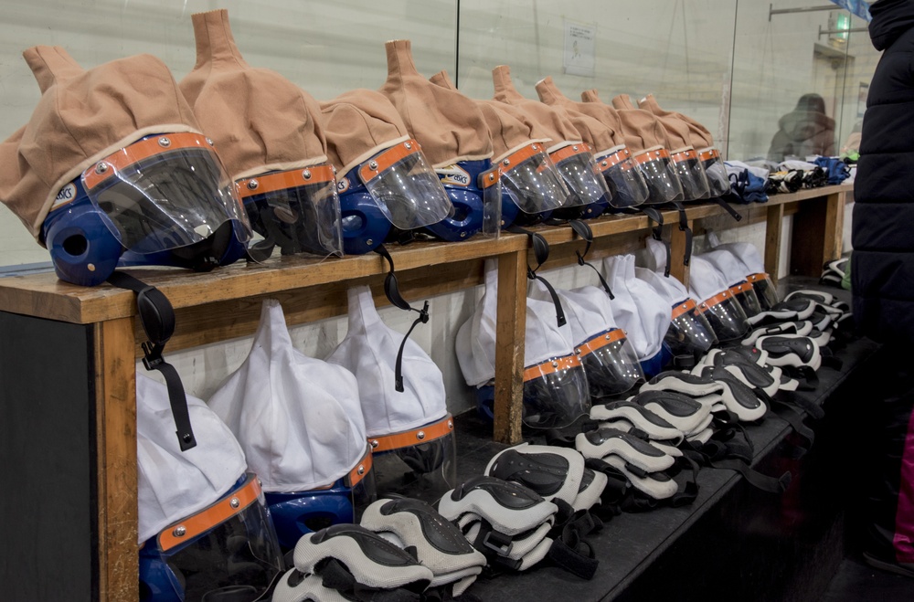 Childrens ice hockey gear lines the holding racks