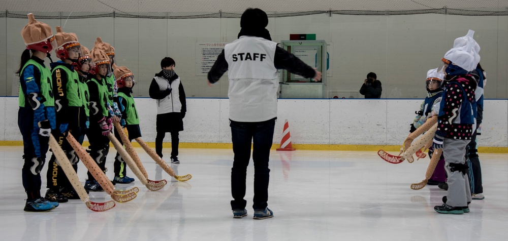 Two teams bow to each other before a match in the Misawa ice hockey competition