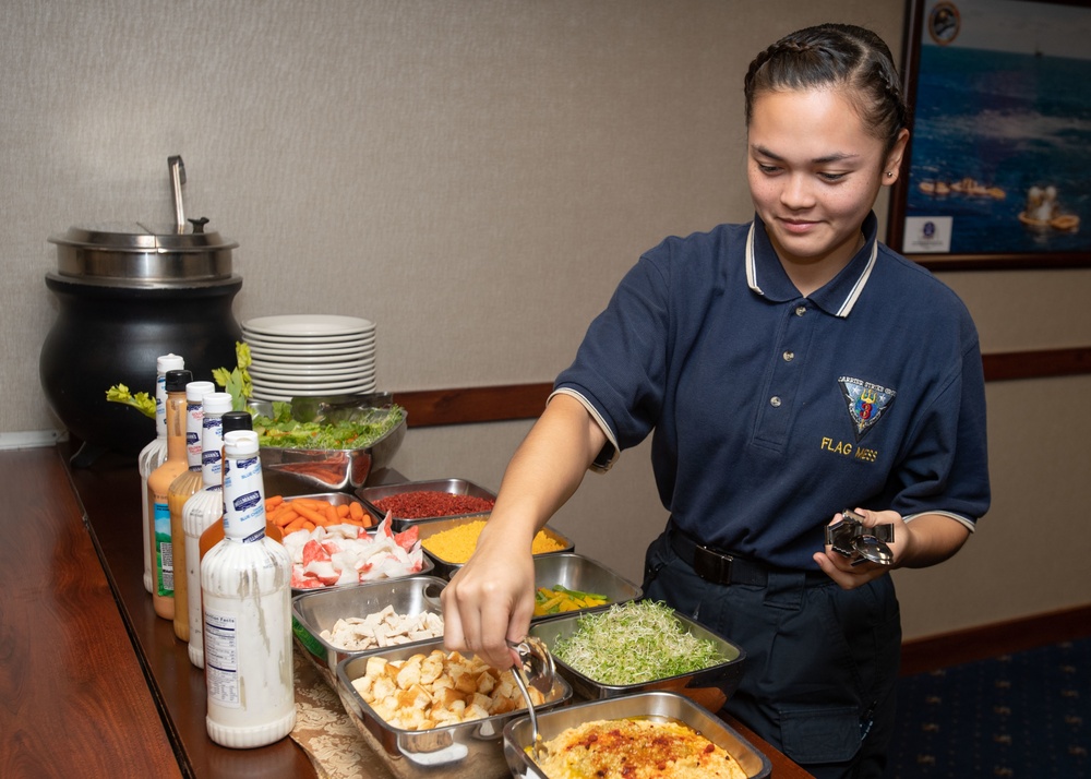 U.S. Sailor prepares a salad bar