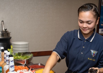U.S. Sailor prepares a salad bar