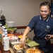 U.S. Sailor prepares a salad bar