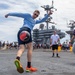 U.S. Sailor dribbles a soccer ball during a steel beach picnic