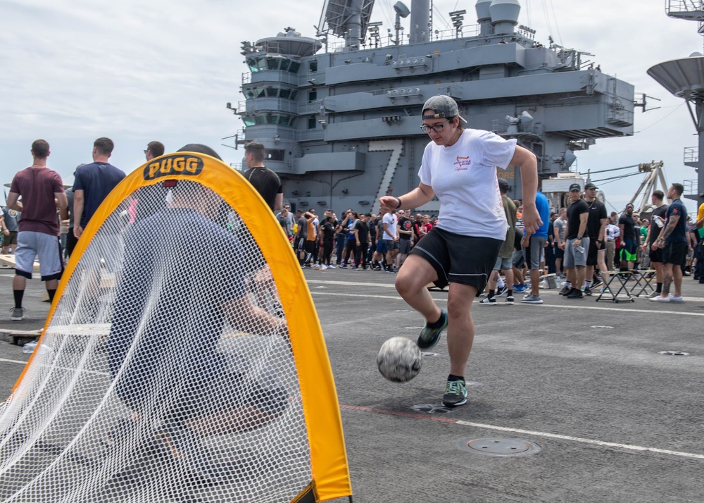 U.S. Sailor plays soccer during a steel beach picnic