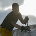 Sailor works on snow sculpture