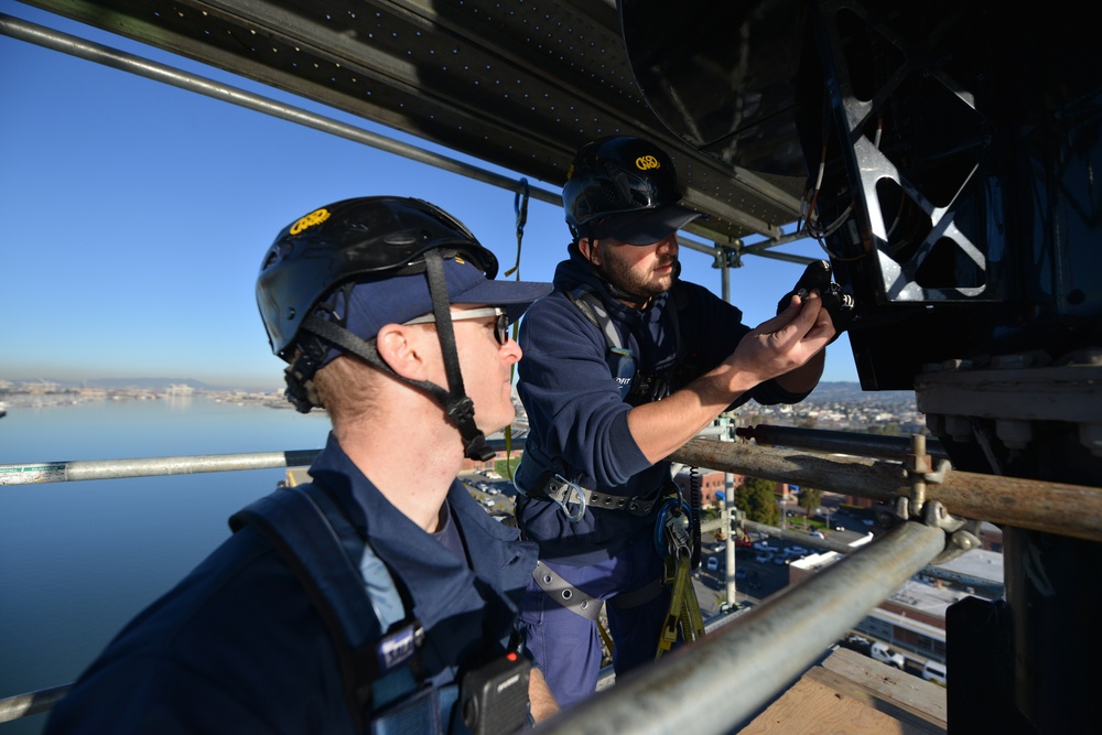 Coast Guard electronics technicians repair critical equipment aboard National Security Cutter while 147’ feet above sea level