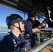 Coast Guard electronics technicians repair critical equipment aboard National Security Cutter while 147’ feet above sea level