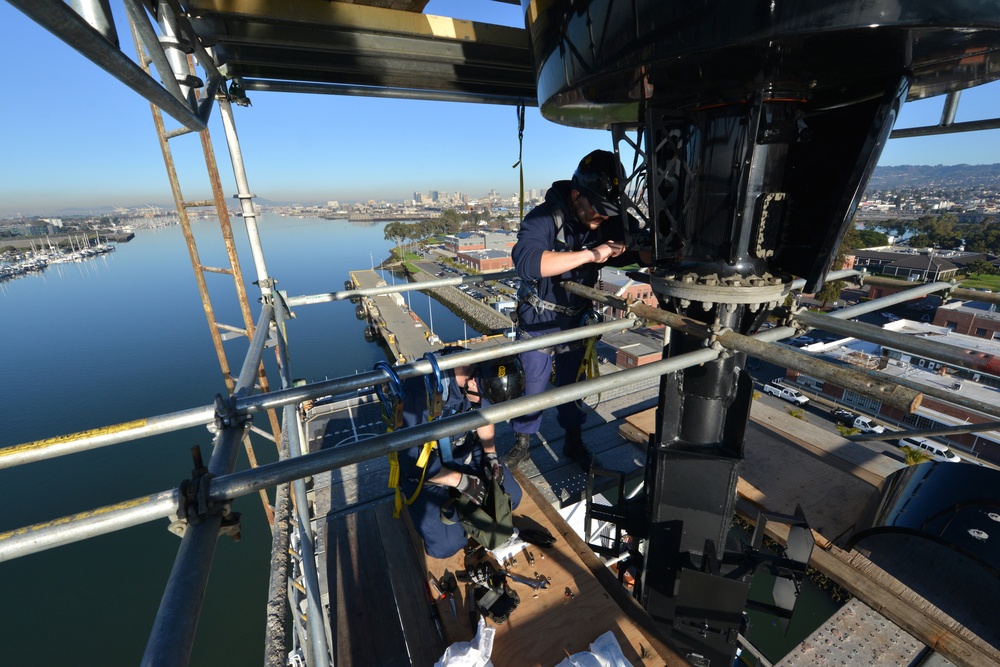 Coast Guard electronics technicians repair critical equipment aboard National Security Cutter while 147’ feet above sea level