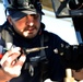 Coast Guard electronics technicians repair critical equipment aboard National Security Cutter while 147’ feet above sea level